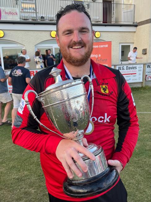 Delighted Carew skipper Rhys Davies with the trophy Delighted Carew skipper Rhys Davies with the trophy
